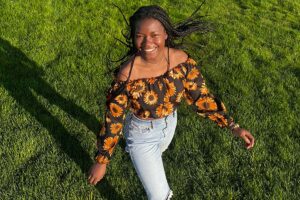 Cynthia walking in grass field
