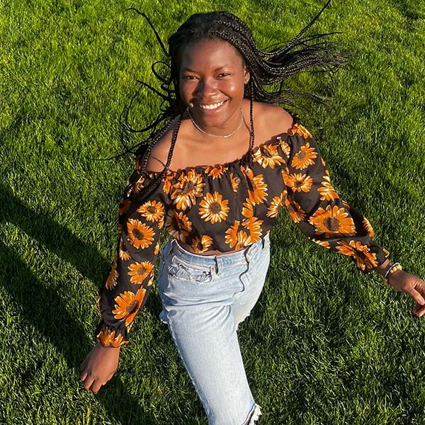 Cynthia walking in grass field